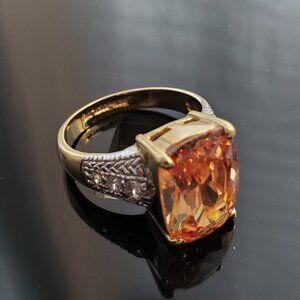 Gold-tone ring set with peachy quartz-colored gem